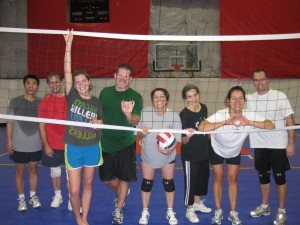 Adults having fun in playing and learning volleyball